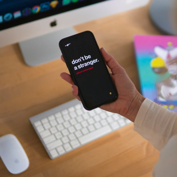 person holding black iPhone displaying don't be stranger